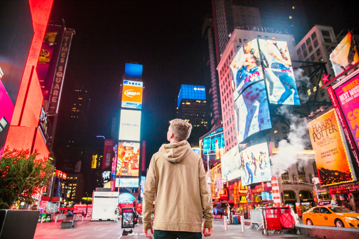 google ads man standing on road infront of high-rise buildi blog