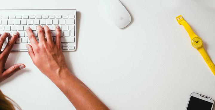 person typing on Apple Cordless Keyboard blog