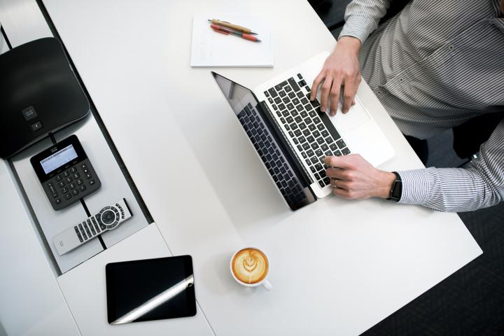 person using laptop on white wooden table blog