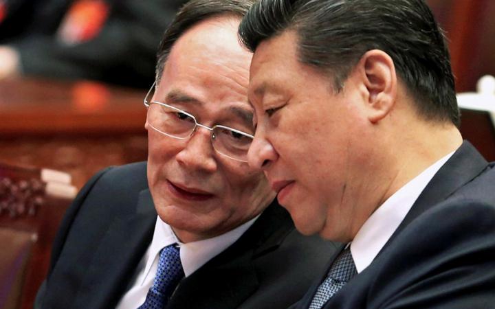 Anticorruption tzar Wang Qishan (L) speaks with Xi Jinping.