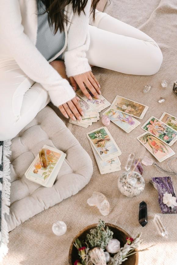 A woman looking at intuitive oracle cards.