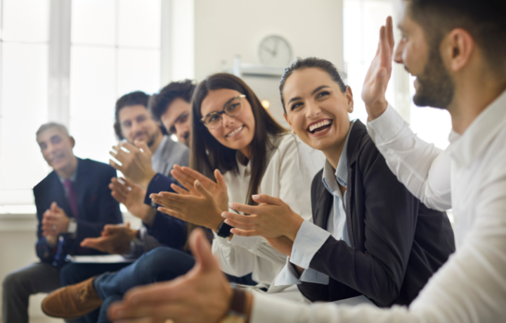 Team recognition, employees clapping for coworker