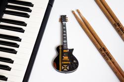 black electric guitar on white surface