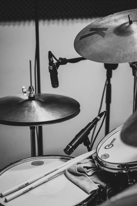 grayscale photo of drum kit