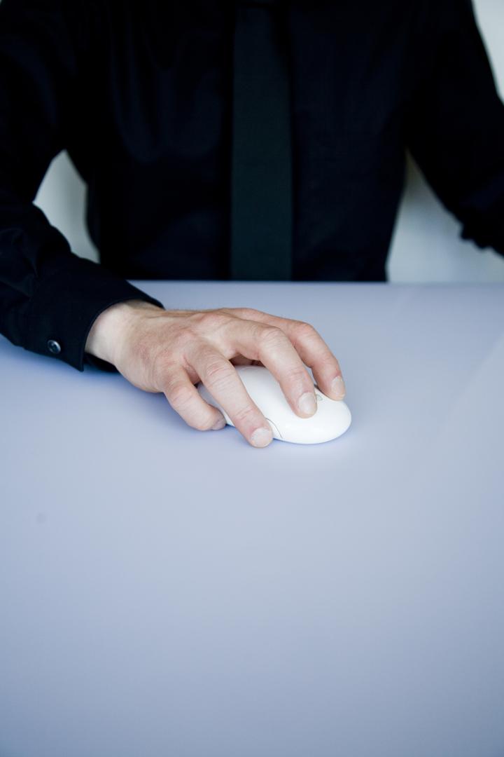 person holding white cordless computer mouse