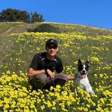 Alex with a dog in the flowers