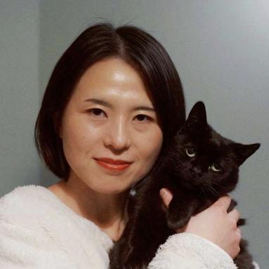 Qian holding a black cat