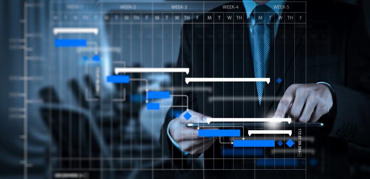 example of gantt chart with a person touching it in an office