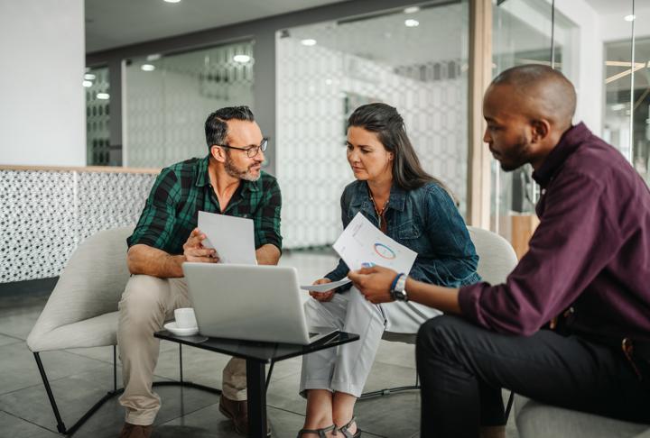 Photograph of team meeting over financial data