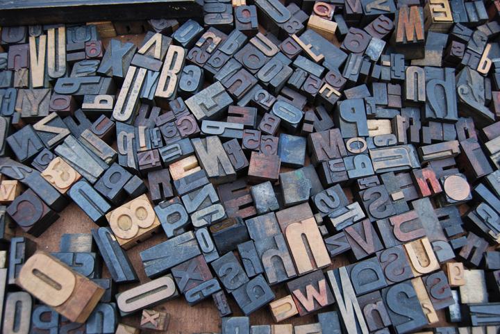 wood stamps of alphabetic letters in various typefaces