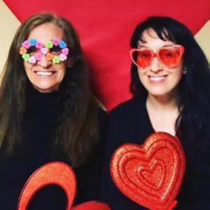 Caregiver smiling with heartglasses with her mother
