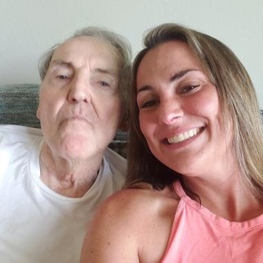 Caregiver taking a smiling selfie with her father