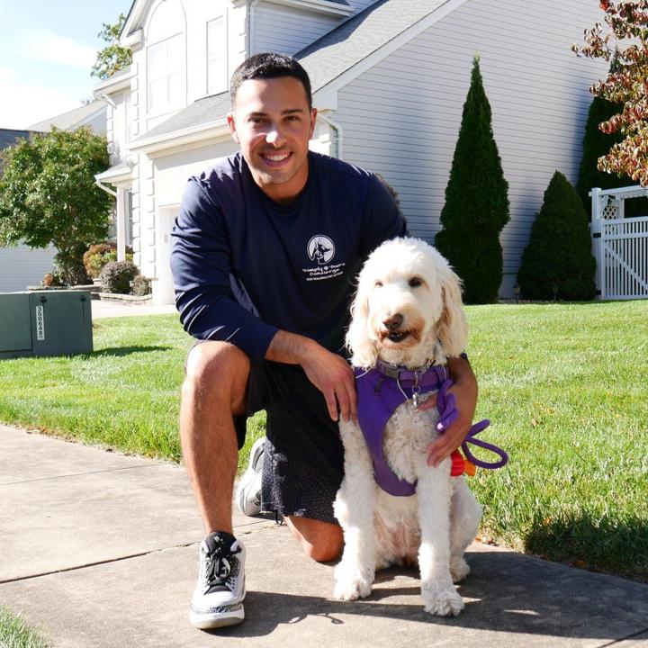 Man kneeling down with a dog