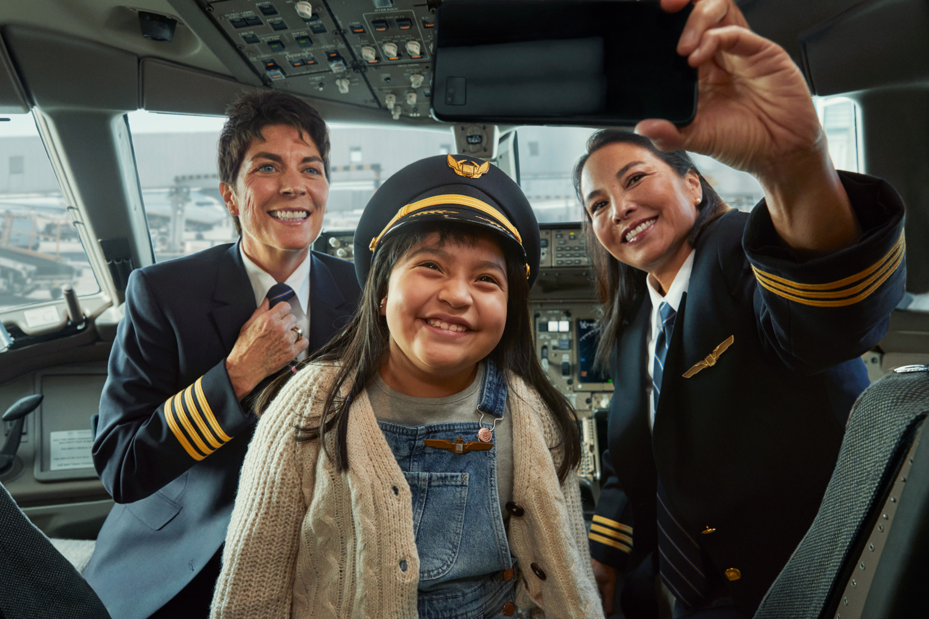 Photo of girl taking a selfie with two female pilots
