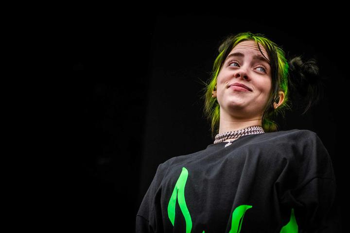 Billie Eilish in black and green shirt