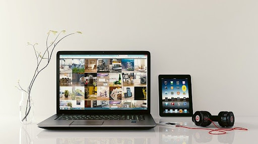 Computer, iPad, and headphones on table