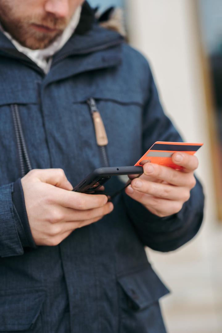 Man with credit card and phone