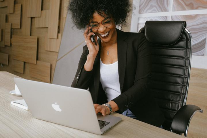 woman in black blazer on phone