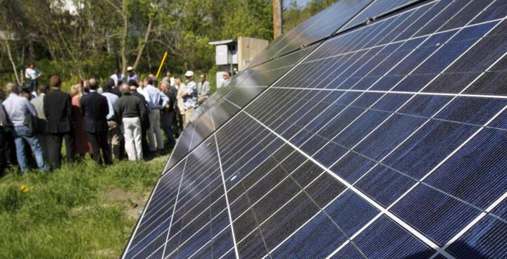 Solar panels next to a crowd of people